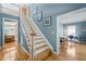 Staircase with wood treads and white risers and a view to an office space, flooded with natural light at 4613 Moores Creek Rd, Durham, NC 27705