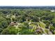 An aerial view showcases homes and the area is filled with lush greenery and trees at 502 S Eighth St, Mebane, NC 27302