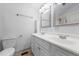 Bright bathroom featuring a double vanity with framed mirrors, and light hardwood flooring at 502 S Eighth St, Mebane, NC 27302