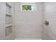 Updated shower showcasing light wood grain tile and recessed shelving at 502 S Eighth St, Mebane, NC 27302
