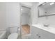 Clean bathroom with hardwood floors and view of the bedroom at 502 S Eighth St, Mebane, NC 27302