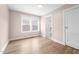 Bedroom featuring light wood floors, a large window, and an ensuite bathroom at 502 S Eighth St, Mebane, NC 27302