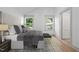 Comfortable bedroom with two windows, neutral decor, a patterned rug, and access to a closet, creating a cozy retreat at 502 S Eighth St, Mebane, NC 27302