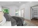 Bright bedroom features natural light, a patterned rug, and access to a spacious walk-in closet, offering comfortable living at 502 S Eighth St, Mebane, NC 27302