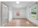 Bright bedroom with light wood flooring, large windows, and an attached bathroom at 502 S Eighth St, Mebane, NC 27302