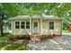 Charming single-story home featuring a quaint entrance, metal roof, and a well-maintained landscaped front yard at 502 S Eighth St, Mebane, NC 27302