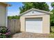 Garage with a white door and purple flowers at 502 S Eighth St, Mebane, NC 27302