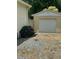 Exterior view of detached garage with gravel driveway and blooming hydrangeas at 502 S Eighth St, Mebane, NC 27302