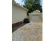 Exterior view of detached garage with gravel driveway and blooming hydrangeas at 502 S Eighth St, Mebane, NC 27302