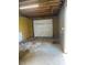 Inside the garage, featuring a white garage door and stained concrete floor at 502 S Eighth St, Mebane, NC 27302