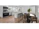 Open kitchen with stainless steel appliances, butcher block island, white cabinets, and combined dining and kitchen area at 502 S Eighth St, Mebane, NC 27302