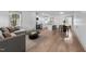 Bright living room with modern furnishings, hardwood floors, and an open layout flowing into the kitchen and dining area at 502 S Eighth St, Mebane, NC 27302