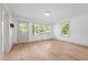 Bright living room with large windows offering natural light, and light wood flooring at 502 S Eighth St, Mebane, NC 27302