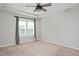 Bedroom with tray ceiling, ceiling fan and bright window dressed with curtains at 513 Brooks St, Wake Forest, NC 27587
