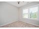 Bedroom with ceiling fan, bright sunny window with plantation shutters and neutral carpet at 513 Brooks St, Wake Forest, NC 27587