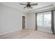 Spacious bedroom featuring a tray ceiling, ceiling fan, and sunny window at 513 Brooks St, Wake Forest, NC 27587