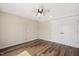 Bright bedroom featuring hardwood floors, a ceiling fan, and a closet with double doors at 513 Brooks St, Wake Forest, NC 27587