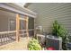 Home exterior featuring a modern HVAC unit surrounded by shrubbery and a screened in porch at 513 Brooks St, Wake Forest, NC 27587