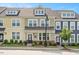 Charming multi-colored townhome featuring manicured landscaping and inviting front entrances at 513 Brooks St, Wake Forest, NC 27587