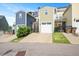 Multi-colored townhomes with front garages offer private driveways and neighborhood charm at 513 Brooks St, Wake Forest, NC 27587
