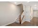 Inviting foyer featuring hardwood floors, a staircase with wooden banister and neutral paint at 513 Brooks St, Wake Forest, NC 27587