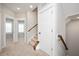 Hallway with carpet and wooden trim features, with views to other rooms and staircase at 513 Brooks St, Wake Forest, NC 27587