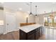 Kitchen island with bar seating, pendant lighting and direct access to an outdoor deck at 513 Brooks St, Wake Forest, NC 27587