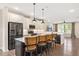 Contemporary kitchen featuring an island with bar seating, stainless appliances, and hardwood floors at 513 Brooks St, Wake Forest, NC 27587