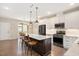 Modern kitchen featuring an island with bar seating, stainless steel appliances, and white cabinets at 513 Brooks St, Wake Forest, NC 27587