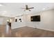 Open concept living room with hardwood floors, ceiling fan and views of the kitchen at 513 Brooks St, Wake Forest, NC 27587