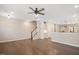 Open concept living room with hardwood floors, a ceiling fan and views of the staircase at 513 Brooks St, Wake Forest, NC 27587