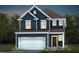 Two story home featuring board and batten siding, a two car garage, and a covered entry at 529 Prestonfield Way, Raleigh, NC 27603