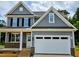 Charming two-story home with gray siding, black shutters, and a spacious white two-car garage at 5905 Genesee Dr., Homesite 6, Durham, NC 27712