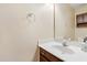 Bathroom sink and vanity with neutral colors and a large mirror at 613 Penncross Dr, Raleigh, NC 27610