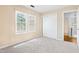 Bedroom featuring carpet, closet with sliding door, and two windows at 613 Penncross Dr, Raleigh, NC 27610