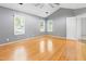 Spacious bedroom featuring three windows and hardwood floors at 613 Penncross Dr, Raleigh, NC 27610