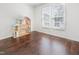 A bedroom with hardwood floors, white walls, and bright double windows at 613 Penncross Dr, Raleigh, NC 27610