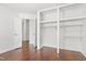 Bedroom featuring a spacious closet with built-in shelves and hanging rods with wood-look floors at 613 Penncross Dr, Raleigh, NC 27610