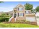 Inviting two-story home with brick-lined steps and manicured landscaping, plus a garage at 613 Penncross Dr, Raleigh, NC 27610