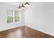 Bright living area with hardwood floors, white walls, and a large window at 613 Penncross Dr, Raleigh, NC 27610