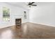 Living room with wood-look floors, fireplace, and bright windows at 613 Penncross Dr, Raleigh, NC 27610