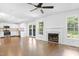 Open concept living and kitchen area with fireplace, windows, and stainless steel appliances at 613 Penncross Dr, Raleigh, NC 27610