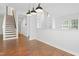 Open concept living space with hardwood floors, white walls, and staircase view at 613 Penncross Dr, Raleigh, NC 27610