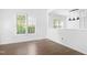 Bright living room showcasing hardwood floors, white walls, with a window view at 613 Penncross Dr, Raleigh, NC 27610