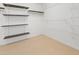 Empty walk-in closet with shelving and carpeted floor at 613 Penncross Dr, Raleigh, NC 27610