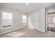 Bright bedroom with carpet, two windows, and closet at 66 W Emily Gardens Dr, Selma, NC 27576