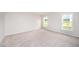Well-lit bedroom features plush carpeting and two large windows, offering a comfortable and inviting space at 66 W Emily Gardens Dr, Selma, NC 27576
