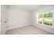 Well-lit bedroom with carpet and a view of the lawn at 66 W Emily Gardens Dr, Selma, NC 27576
