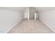 A large bonus room features neutral carpeting and a vaulted ceiling with a staircase at 66 W Emily Gardens Dr, Selma, NC 27576