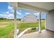 Covered patio view overlooking the spacious backyard and the exterior of a home at 66 W Emily Gardens Dr, Selma, NC 27576